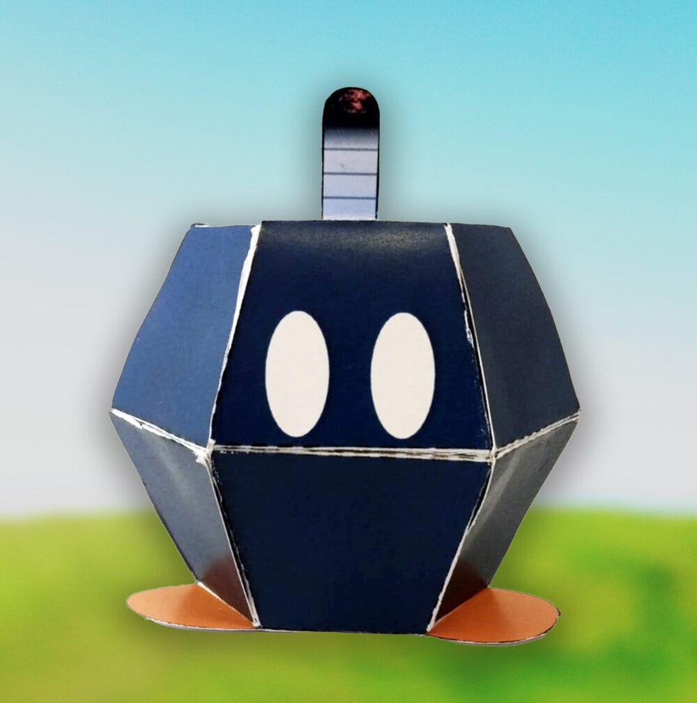 Crea tu propio Bob-omb en papel con esta plantilla descargable. Manualidad divertida, educativa y ecológica para niños y fans de Mario.